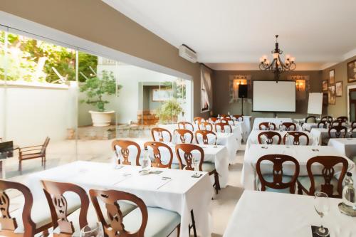 
a large dining room with tables and chairs at Audacia Manor Boutique Hotel in Durban
