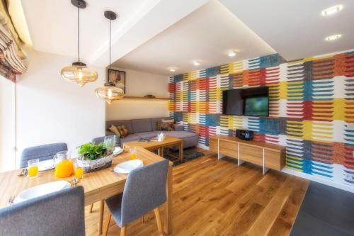 a dining room with a large colorful wall at Polana Szymoszkowa Ski Resort in Zakopane