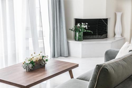 a living room with a coffee table and a fireplace at DN Sea Apartments in Kalamata