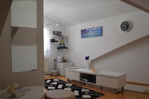 a living room with a white table and a staircase at Apartment Prima in Koper