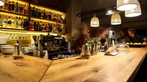 a bar with a wooden counter with bottles of alcohol at White Lavina - Ski, Bike, Hike in Bansko