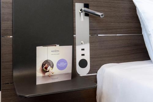 a box on a table next to a bed at Novotel Paris Coeur d'Orly Airport in Orly