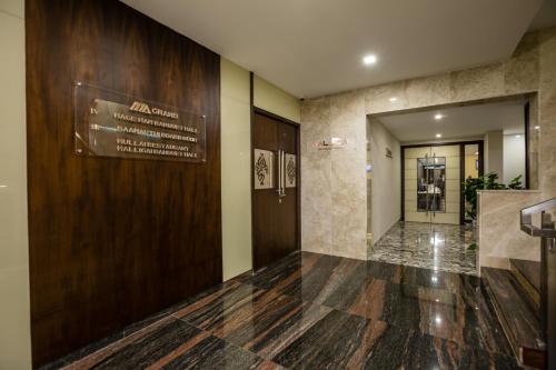 a lobby of a building with a sign on the wall at Hotel Ma Grand in Pudukkottai
