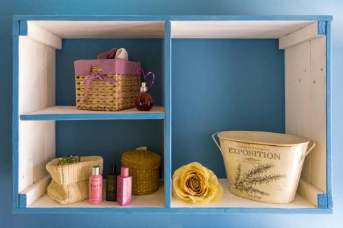 a blue shelf with some items on it at B&B Amici del Colle in San Colombano al Lambro