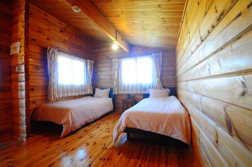 Ένα ή περισσότερα κρεβάτια σε δωμάτιο στο Pension Yonaha Dake