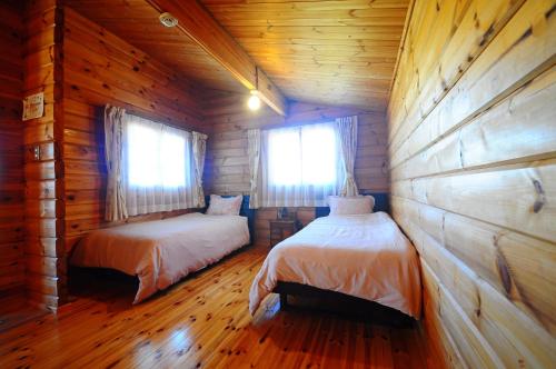 Postel nebo postele na pokoji v ubytování Pension Yonaha Dake
