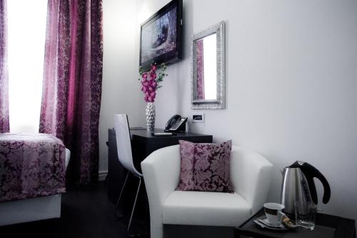 a living room with a white chair and a desk at Sleep Split in Split