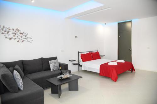 a living room with a couch and a bed at City Heart Luxury Studios in Rhodes Town