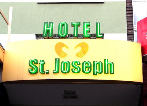 a hotel st joseph sign on top of a building at St.Joseph Hotel Hamburg - Reeperbahn St.Pauli Kiez in Hamburg