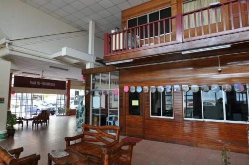 a lobby of a store with a table and chairs at KT Beach Resort in Kuala Terengganu