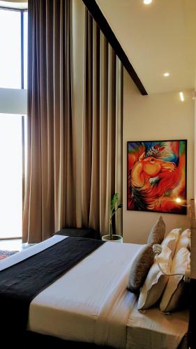 a bedroom with a bed with a painting on the wall at The Saneer Jaipur in Jaipur