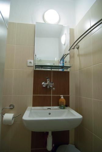 a bathroom with a sink and a mirror at Fontana Pizzeria - Pension in České Budějovice