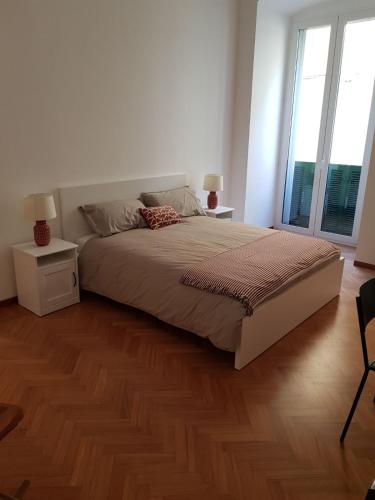 a bedroom with a large bed with a wooden floor at BorgoAntico34 - Luxury Room in Molfetta
