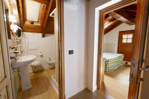 a bathroom with a sink and a toilet in a room at Agriturismo Giacomino in Gera Lario