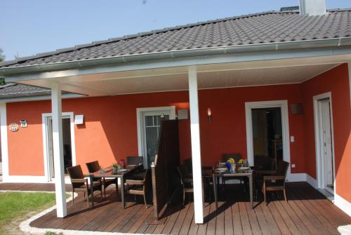 a patio with tables and chairs on a deck at Reiger Ferienwohnungen in Wackersdorf