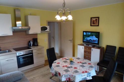 a kitchen and dining room with a table and a kitchen at Reiger Ferienwohnungen in Wackersdorf
