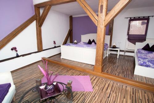a attic room with a bed and a purple rug at Fontana Pizzeria - Pension in České Budějovice