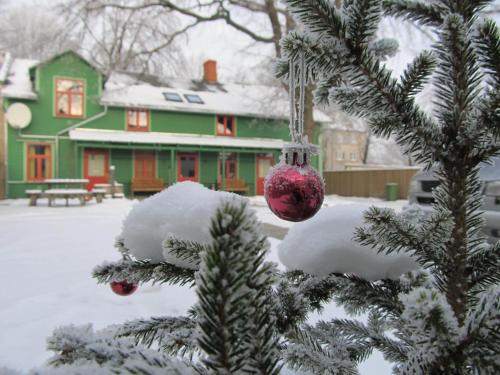 a christmas ornament hanging from a christmas tree at Raibie Logi in Ventspils