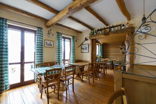 a dining room with wooden floors and tables and chairs at Agriturismo Giacomino in Gera Lario