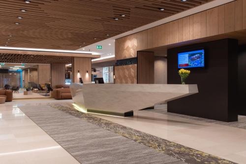 a lobby with a reception desk in a building at Rikli Balance Hotel – Sava Hotels & Resorts in Bled
