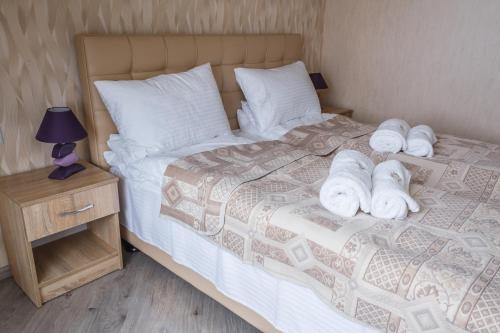 a bedroom with a bed with towels on it at Hostynnyy Dvir in Stryi