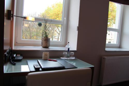 a desk in a room with a window at Adena Hotel in Bremerhaven
