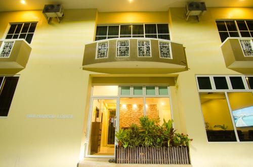 a building with a balcony on top of it at Hulhan'gu Lodge in Himmafushi