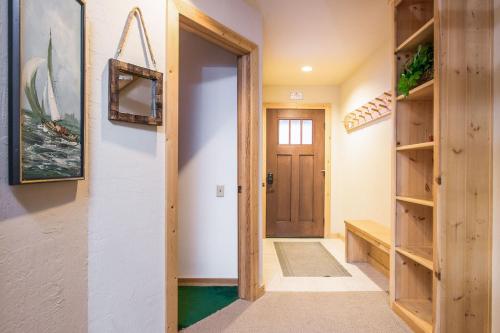 a hallway with a wooden door and shelves at Northstar - Ski Trail Condo in Kingswood Estates