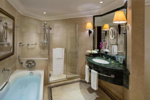 a bathroom with a tub and a sink and a shower at InterContinental Phoenicia Beirut by IHG in Beirut