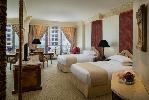 a hotel room with two beds and a television at InterContinental Phoenicia Beirut by IHG in Beirut