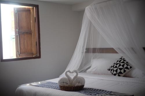 a bedroom with a bed with two hearts on it at The Good Days in Udon Thani