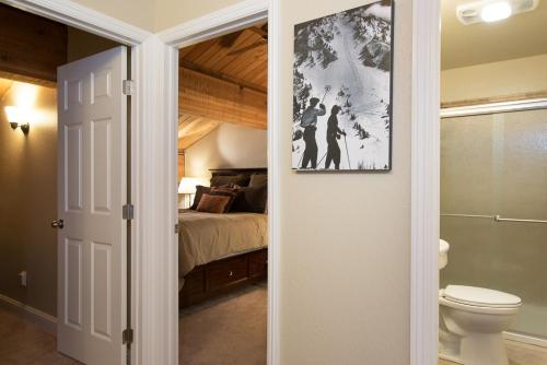 a bathroom with a toilet and a bedroom with a bed at Northstar - Village View in Kingswood Estates
