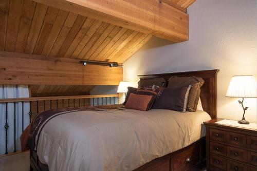 a bedroom with a bed and a wooden ceiling at Northstar - Village View in Kingswood Estates