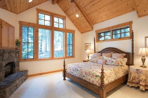 a bedroom with a bed and a fireplace at Northstar - Sierra Gold Home in Kingswood Estates