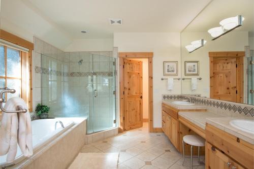 a bathroom with two sinks and a tub and a shower at Northstar - Sierra Gold Home in Kingswood Estates