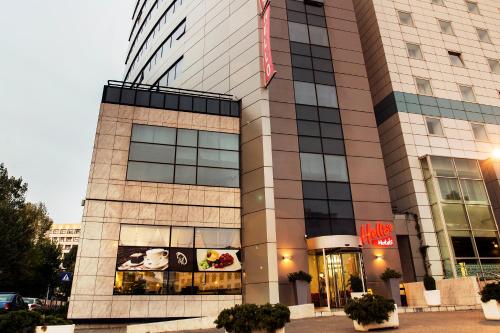 a building with a sign on the side of it at Hello Hotels Bucuresti Gara de Nord in Bucharest