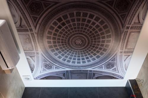 an ornate ceiling in a hallway of a building at Apartamento Quixote Loft Almagro in Almagro