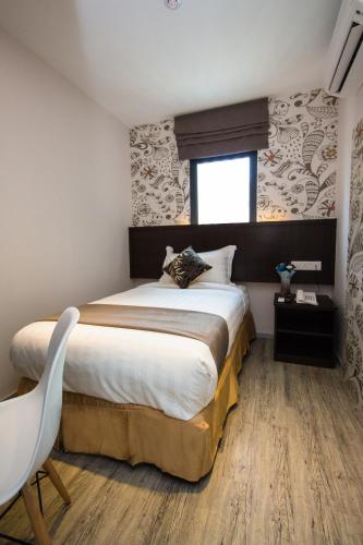 a bedroom with a large bed and a window at Double M Hotel @ Kl Sentral in Kuala Lumpur