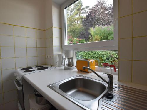 a kitchen with a sink and a window at Ferienhaus Ostseeblick in Kühlungsborn in Kühlungsborn