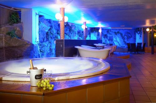 a large bathroom with a tub with grapes on the counter at Bohusgården Hotell & Konferens in Uddevalla