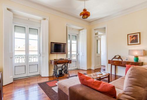 a living room with a couch and a tv at ALTIDO Fernando Pessoa Apartments in Lisbon