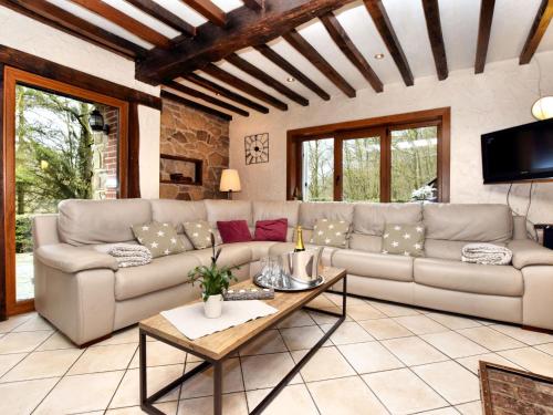 a living room with a couch and a table at Luxurious Villa with Private Pool in Durbuy in Grandhan