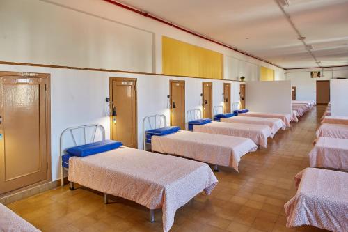 a row of beds in a hospital room at Albergue Seminario Menor in Santiago de Compostela