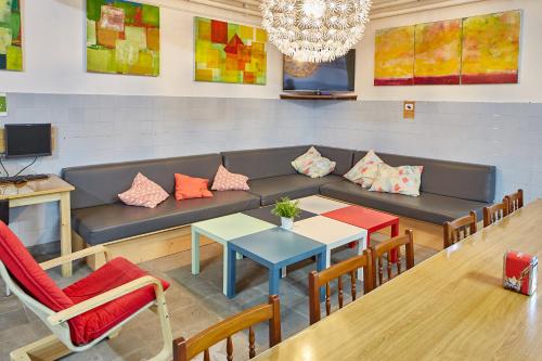 a waiting room with a couch and a table and chairs at Albergue Seminario Menor in Santiago de Compostela