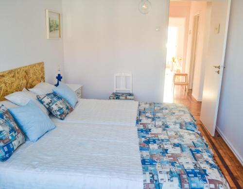 a bedroom with a large bed with blue pillows at Belém River Apartment in Lisbon