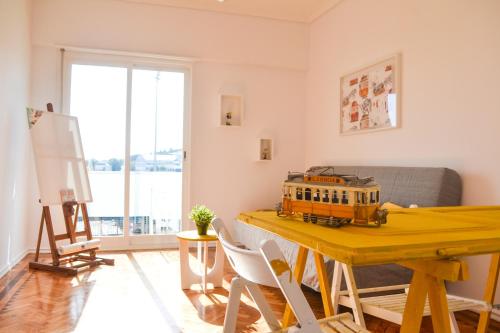 a living room with a table with a train on it at Belém River Apartment in Lisbon