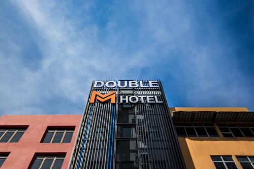 a tall building with a hotel sign on it at Double M Hotel @ Kl Sentral in Kuala Lumpur