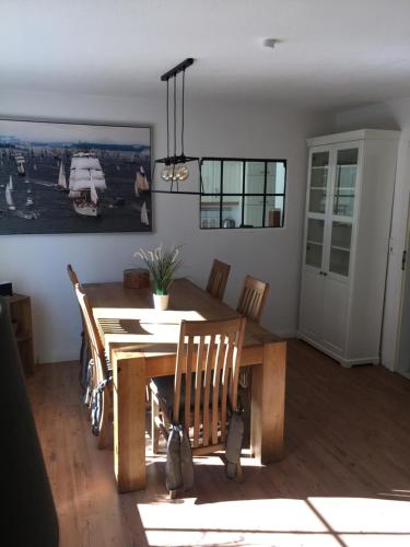a dining room with a wooden table and chairs at Landhaus zum adeligen Klosterforst in Pohnsdorf