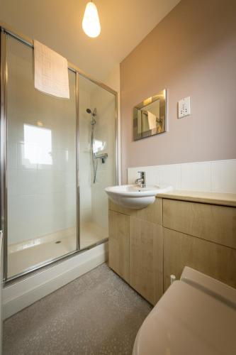 a bathroom with a shower and a sink and a toilet at Taigh Mhuirne in Portree