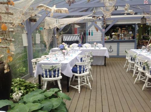 a set of tables and chairs on a deck at SeaPark Hotel Wellness & Spa in Kołobrzeg